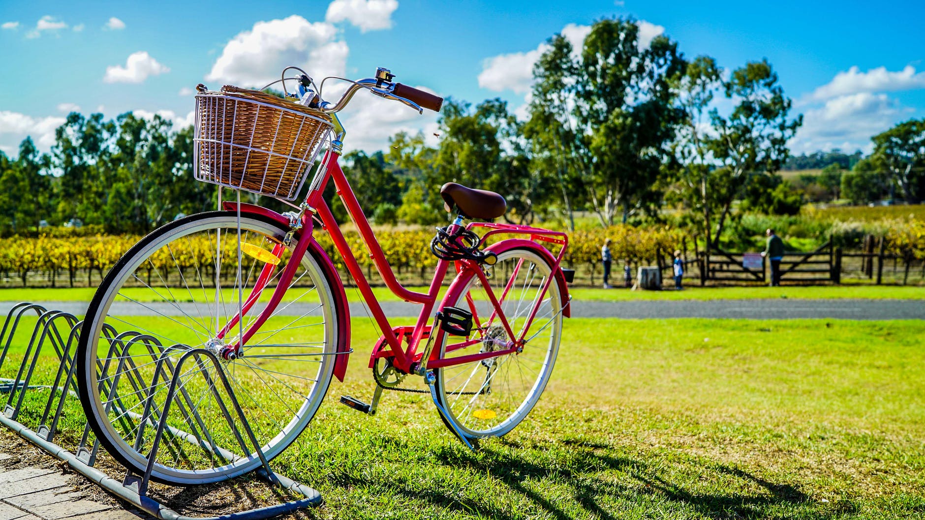 red cruiser bike parked on metal bike stand